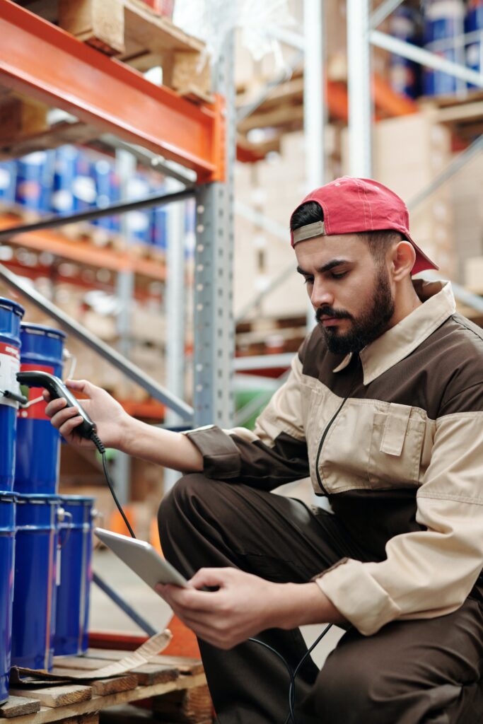 A man scanning warehouse labeling