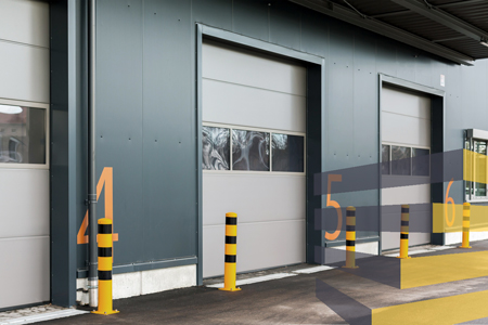 Warehouse bollards located outside docking ports at a warehouse