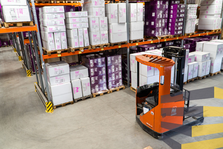 Industrial storage racks and forklift. Petrebels on Unsplash.