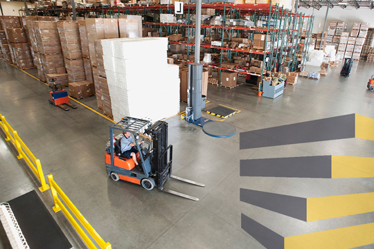 Forklift moving in warehouse to illustrate importance of warehouse guardrail systems